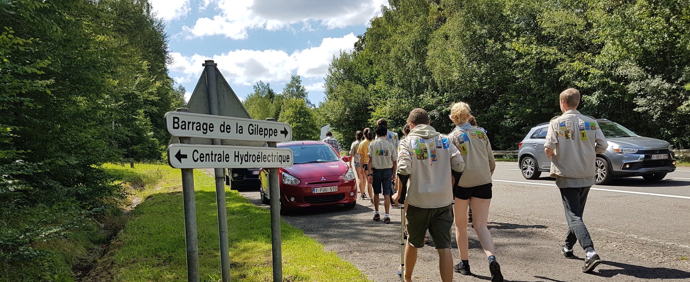 Foto van stappende givers naast auto's